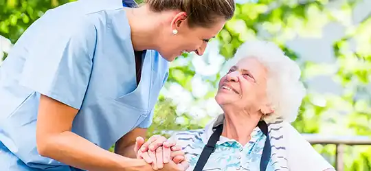 nurse holding hand of elderly patient