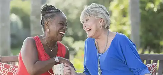 two senior women laughing