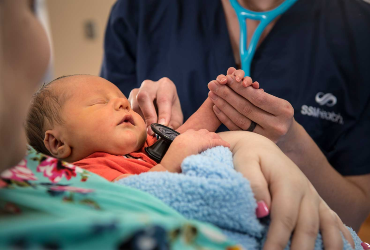 mom holding baby with ssm health delivery nurse